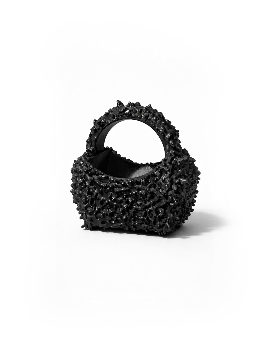 Black textured handbag on a white background